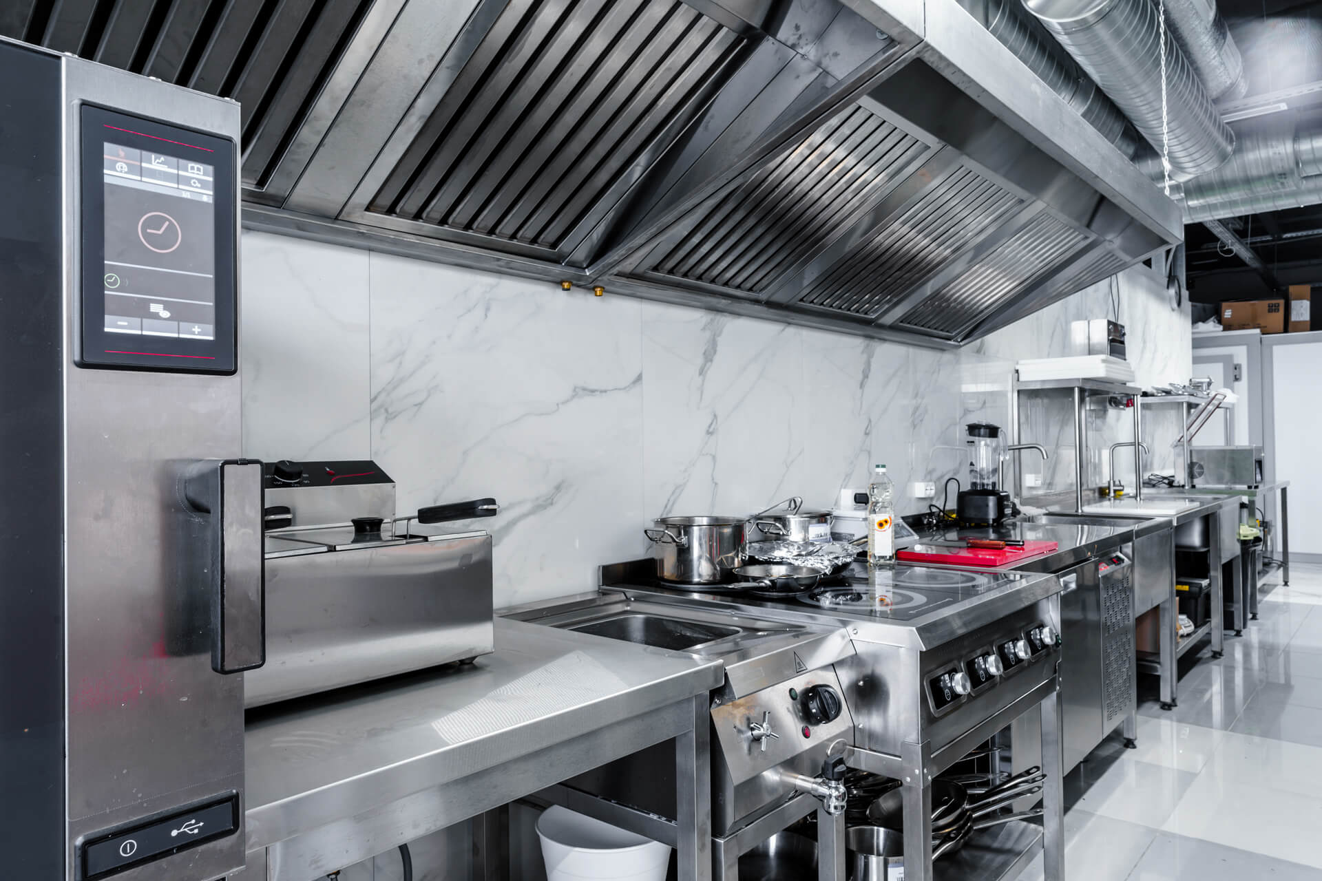 Interior of commercial kitchen with vent hood